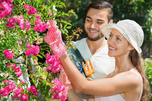 Gardener pruning shrubs in Cricklewood
